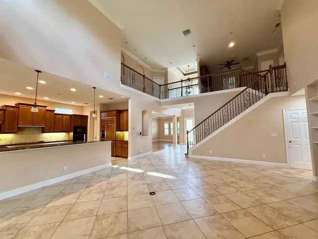 a view of an empty room with a fireplace and a window