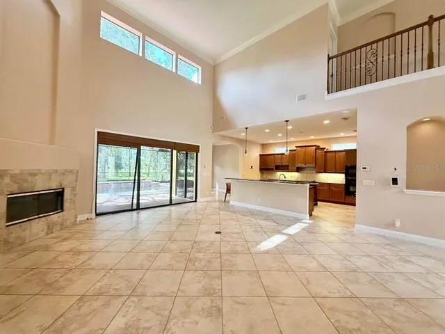 a view of a livingroom with a fireplace and window