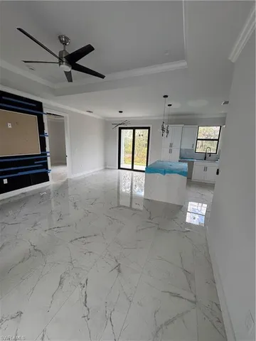 a view of a livingroom with a ceiling fan and window