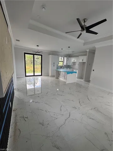 a view of a livingroom with a ceiling fan and window