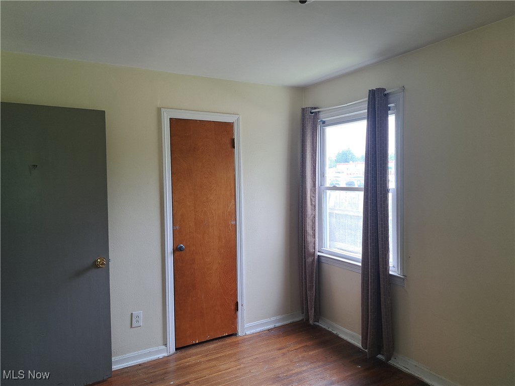 2239 North Ridge Road Lorain, OH 44055 - Photo 16 of 28 Unfurnished bedroom with wood finished floors and baseboards