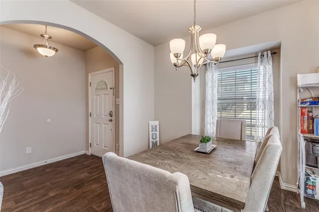 a view of a dining room with furniture wooden floor and chandelier