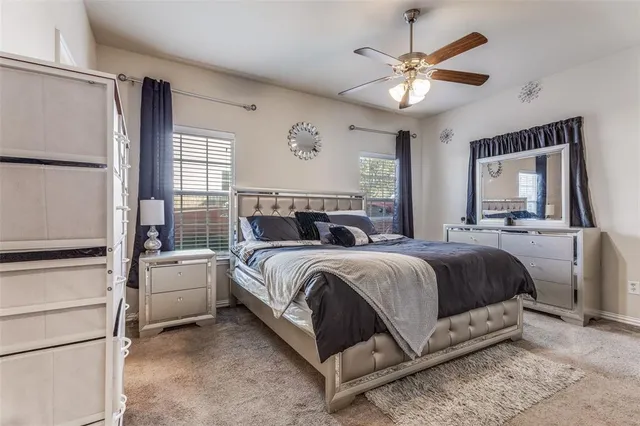 a bedroom with a large bed and a chandelier