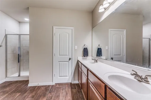 a bathroom with a sink double vanity and a mirror