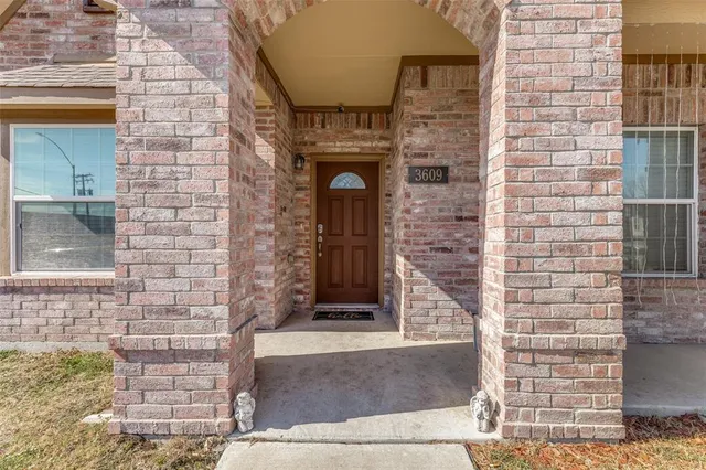 a front view of a brick house with a large windows