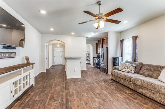 a living room with furniture and a wooden floor