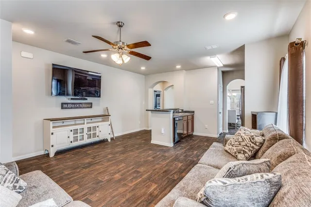 a kitchen with stainless steel appliances kitchen island granite countertop a refrigerator and a stove top oven