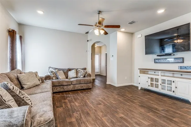 a living room with furniture and a flat screen tv