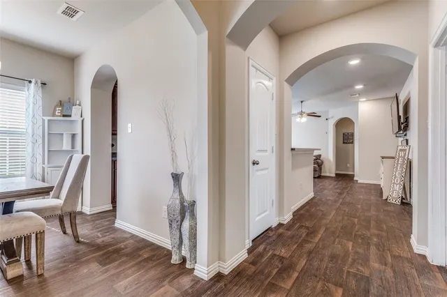 a view of a hallway with wooden floor and stairs