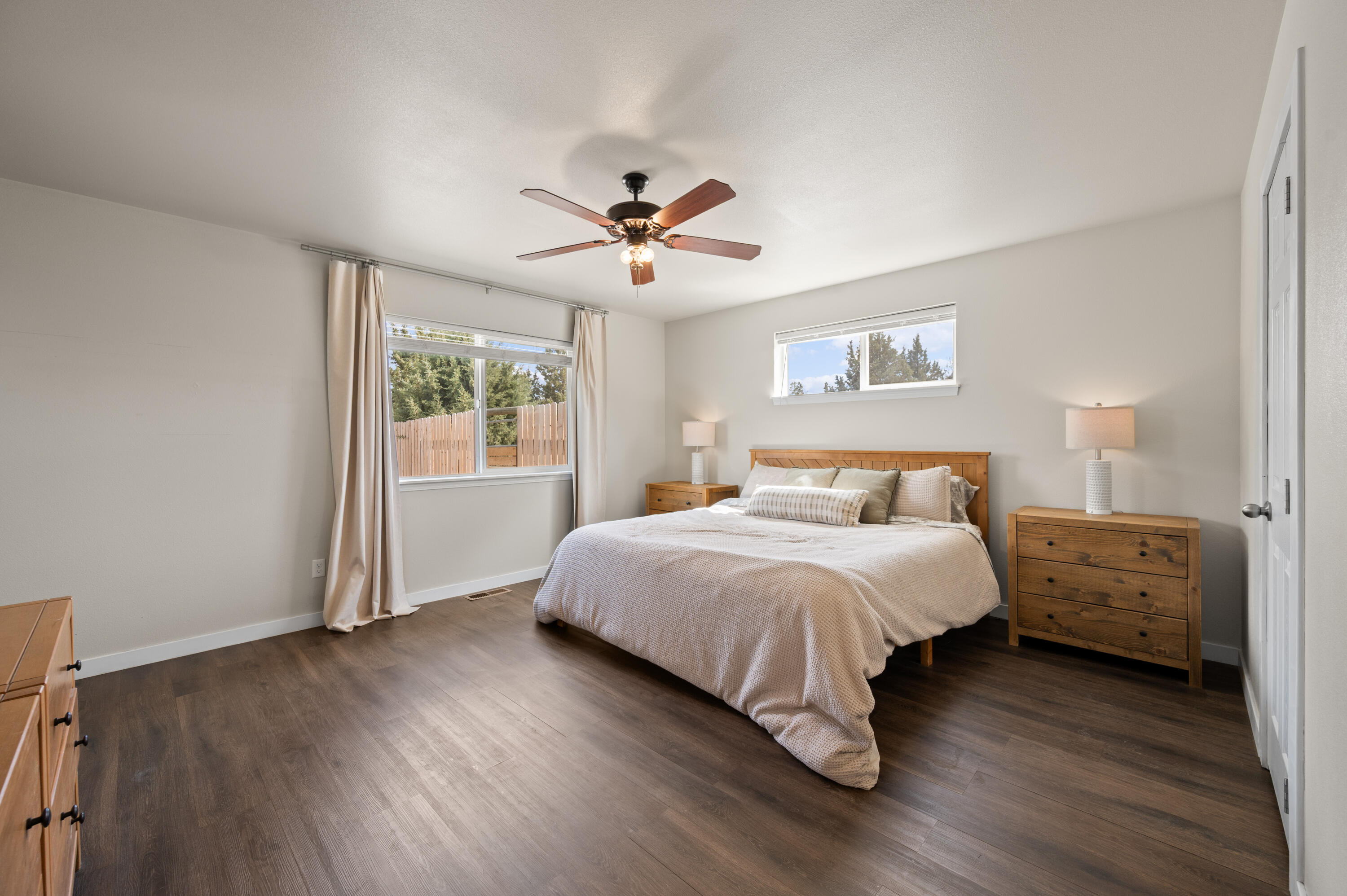16625 Southwest Dove Road Terrebonne, OR 97760 - Photo 22 of 50 a spacious bedroom with a bed and a chandelier