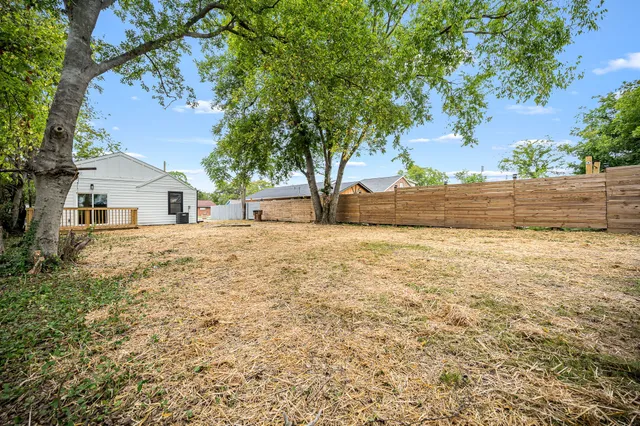 a view of white house with a yard