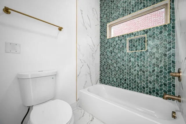 a bathroom with a toilet and a bathtub