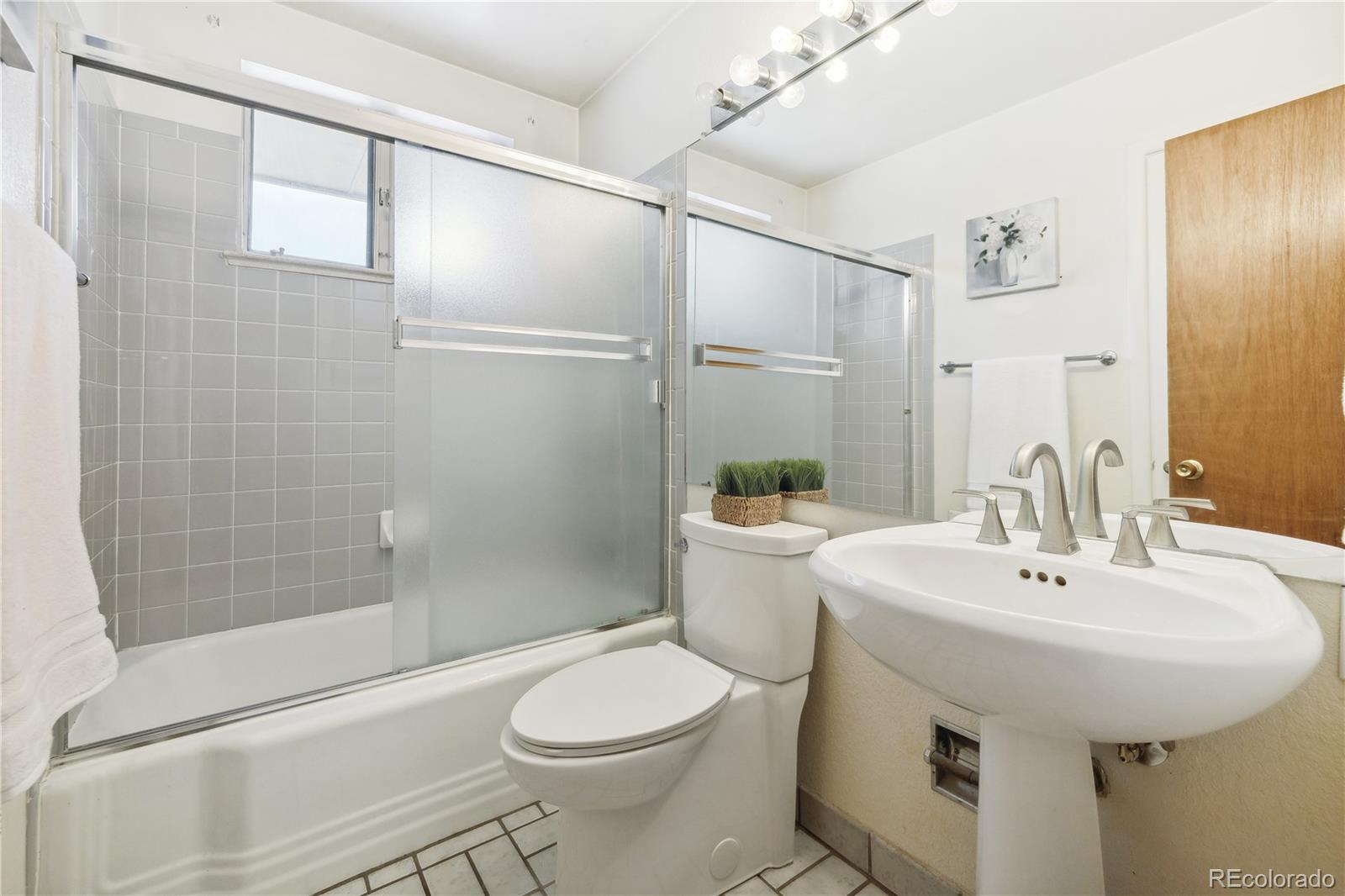 4185 Pierce Street Wheat Ridge, CO 80033 - Photo 14 of 27 a bathroom with a sink toilet and shower