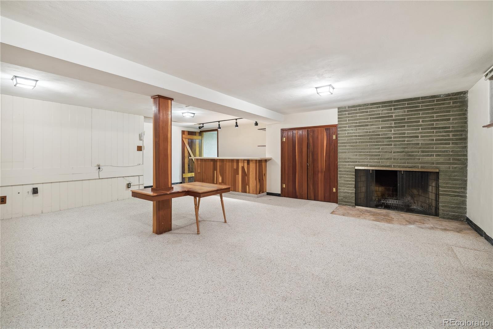 4185 Pierce Street Wheat Ridge, CO 80033 - Photo 17 of 27 an empty room with furniture and a fireplace