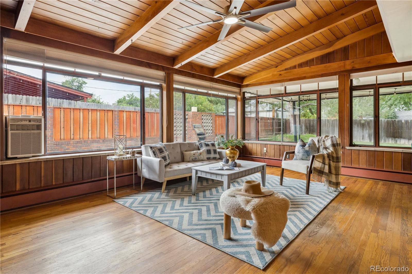 4185 Pierce Street Wheat Ridge, CO 80033 - Photo 2 of 27 a living room with furniture a large window and wooden floor