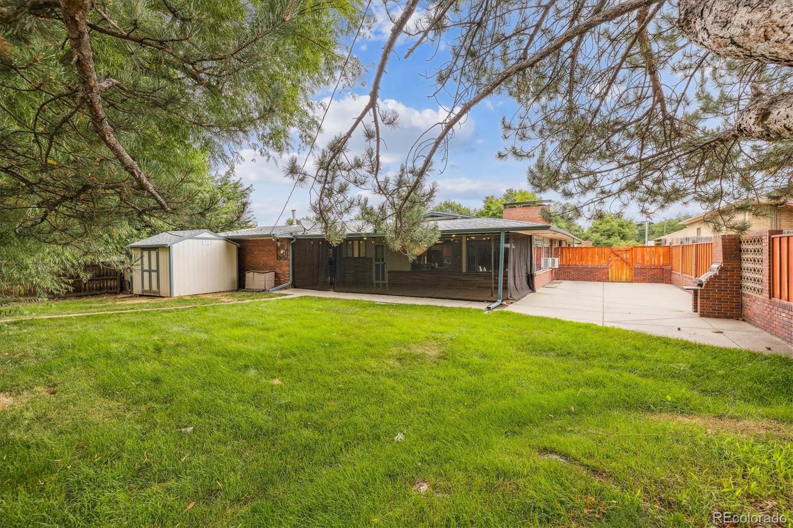 4185 Pierce Street Wheat Ridge, CO 80033 - Photo 21 of 27 a front view of house with yard and trees in the background