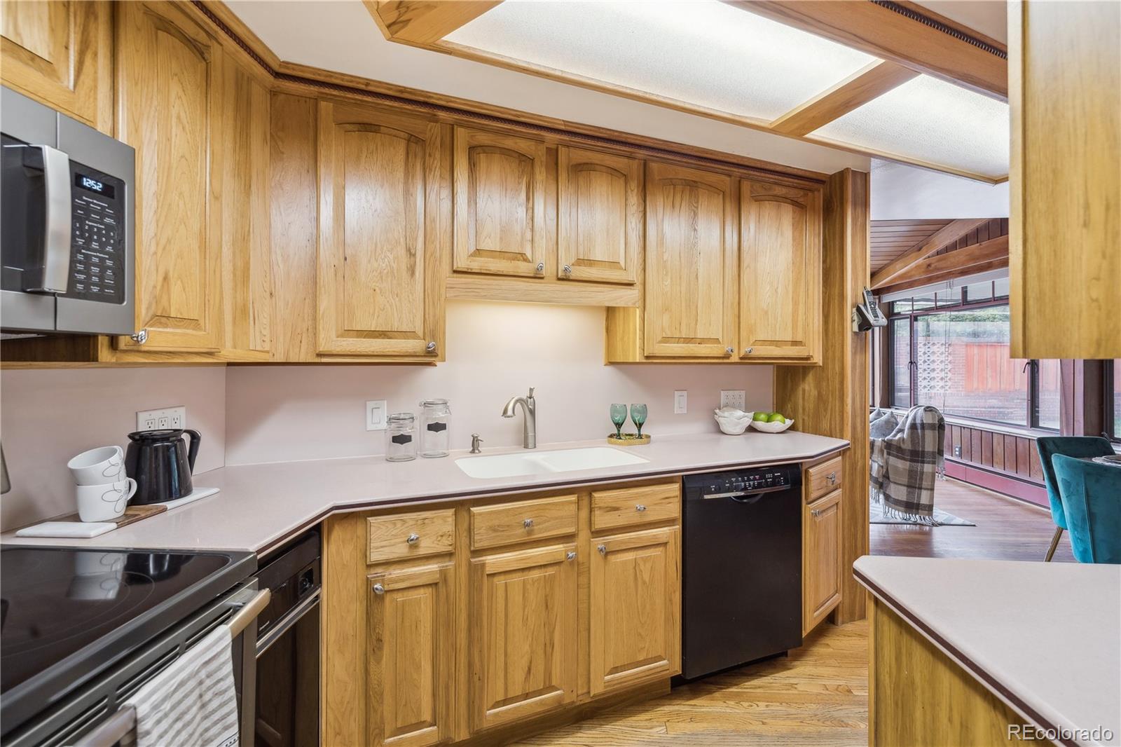 4185 Pierce Street Wheat Ridge, CO 80033 - Photo 8 of 27 a kitchen with stainless steel appliances a sink stove and cabinets