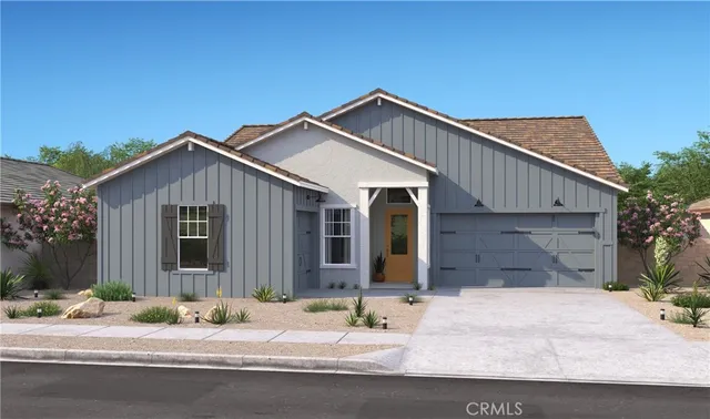 a front view of a house with yard and plants