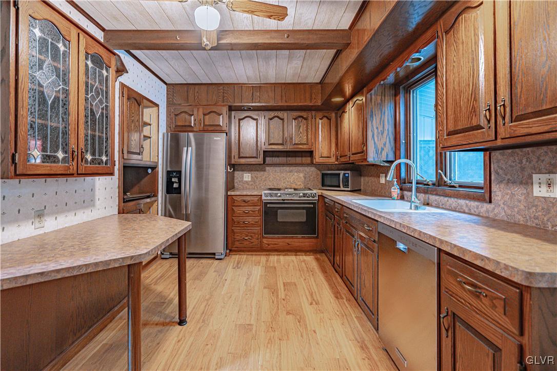 353 Hanover Street Bethlehem, PA 18018 - Photo 12 of 38 a kitchen with stainless steel appliances granite countertop a refrigerator a sink dishwasher a stove and a dining table with wooden floor