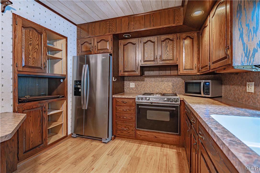 353 Hanover Street Bethlehem, PA 18018 - Photo 13 of 38 a kitchen with granite countertop wooden cabinets stainless steel appliances and a counter space
