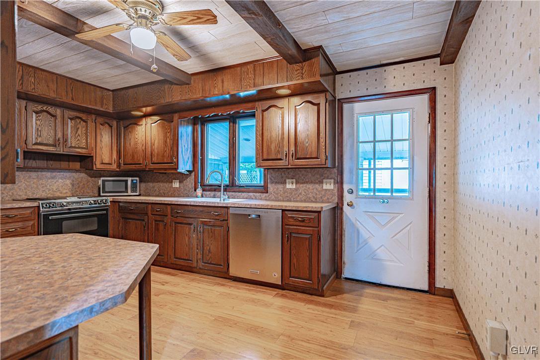 353 Hanover Street Bethlehem, PA 18018 - Photo 10 of 38 a kitchen with stainless steel appliances granite countertop a stove a sink dishwasher and a microwave oven with cabinets