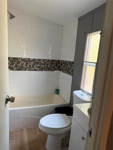 a bathroom with a sink a toilet and a bathtub
