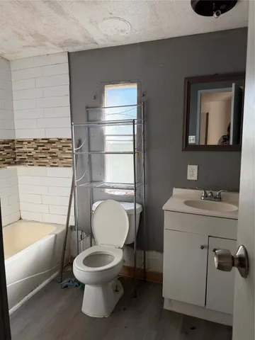 a bathroom with a toilet a sink and a bathtub