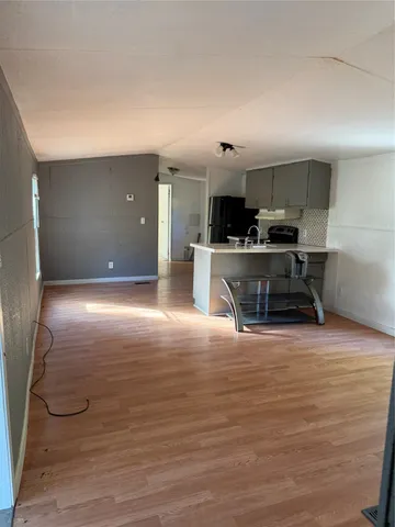 a view of kitchen with kitchen island microwave and stove refrigerator