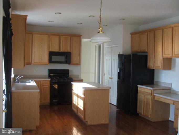 18408 Cornflower Road Boyds, MD 20841 - Photo 8 of 29 a kitchen with stainless steel appliances granite countertop a refrigerator a stove top oven a sink and dishwasher