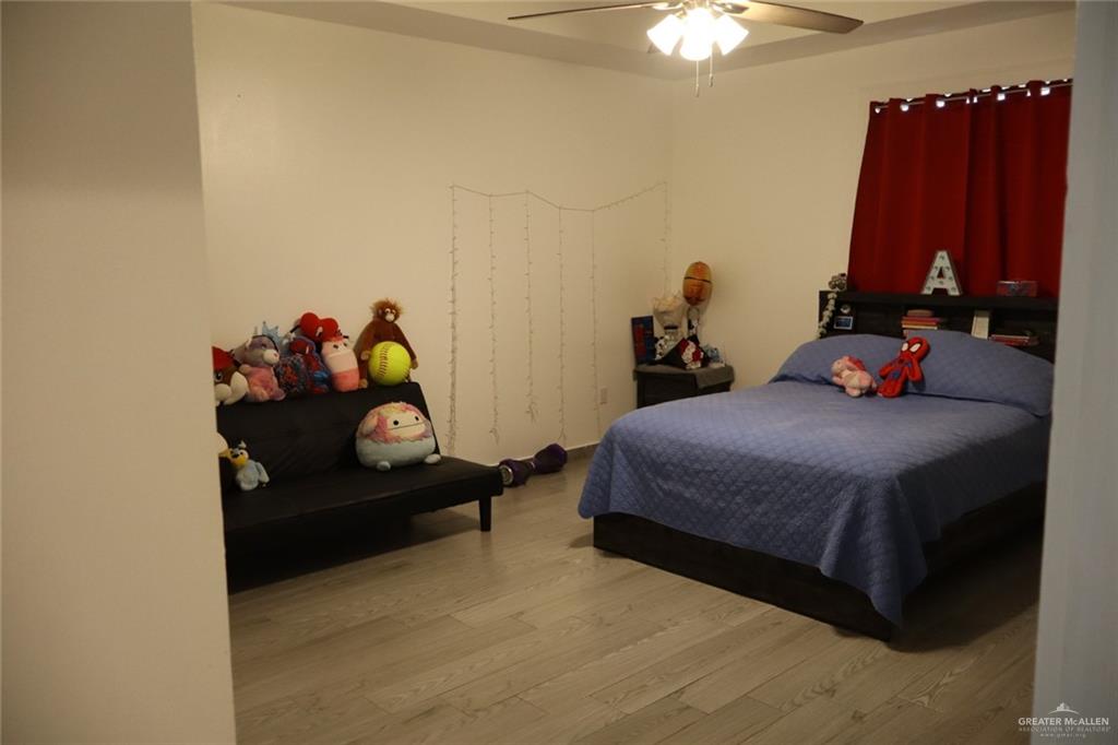 1034 Sunrise Rio Grande City, TX 78582 - Photo 11 of 37 a bedroom with a bed and a chandelier