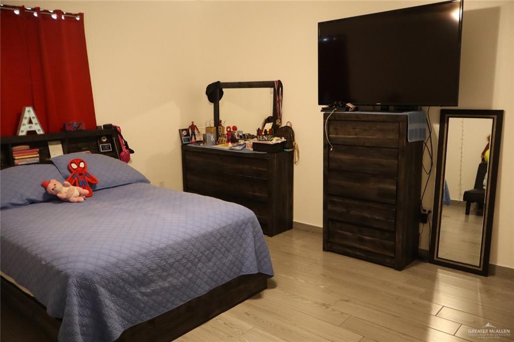 1034 Sunrise Rio Grande City, TX 78582 - Photo 14 of 37 a bedroom with a bed and a flat screen tv