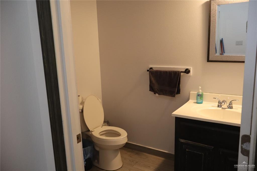 1034 Sunrise Rio Grande City, TX 78582 - Photo 17 of 37 a bathroom with a toilet a sink and mirror