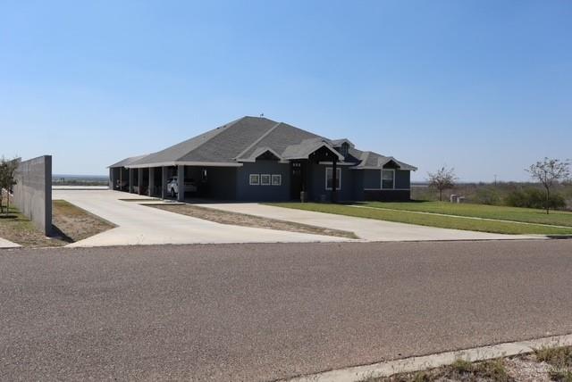 1034 Sunrise Rio Grande City, TX 78582 - Photo 2 of 37 a front view of a house with a yard and garage
