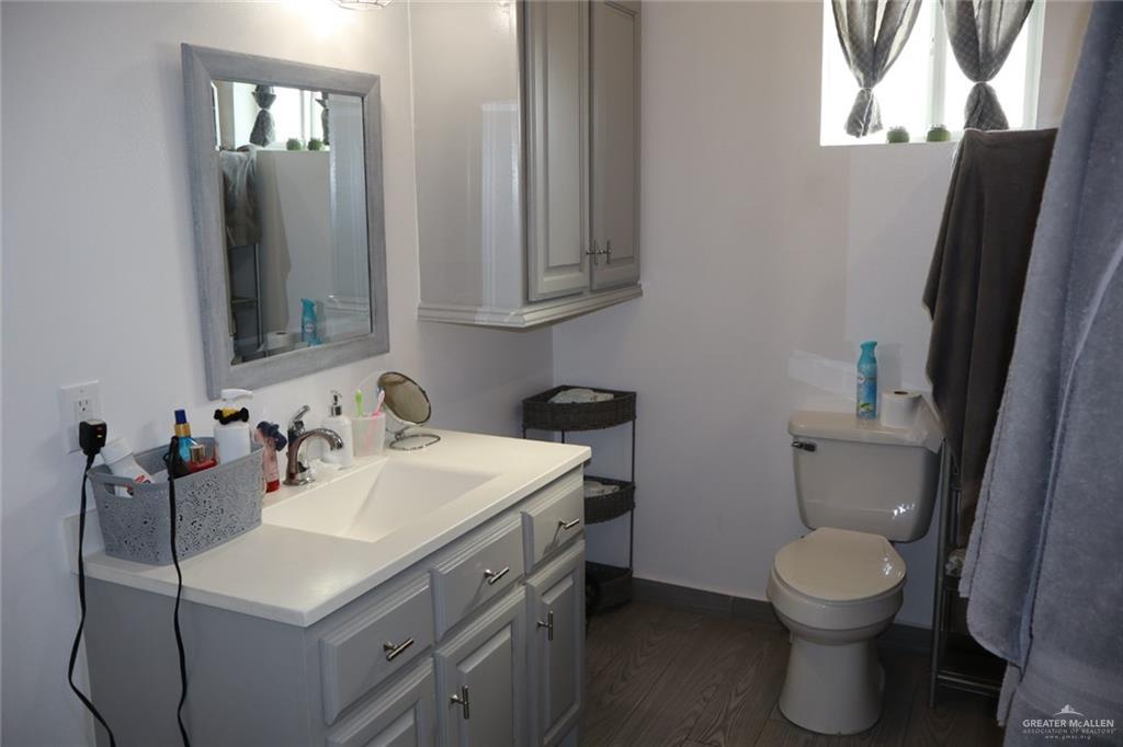 1034 Sunrise Rio Grande City, TX 78582 - Photo 23 of 37 a bathroom with a toilet sink and mirror