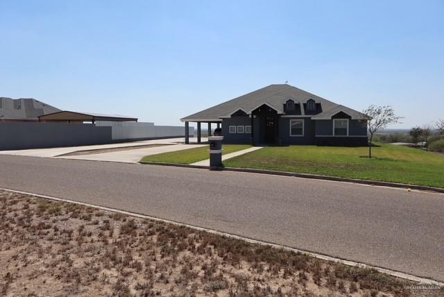 1034 Sunrise Rio Grande City, TX 78582 - Photo 3 of 37 a front view of a house with a yard