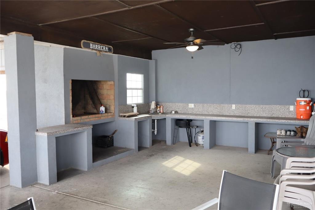 1034 Sunrise Rio Grande City, TX 78582 - Photo 31 of 37 a living room with stainless steel appliances kitchen island granite countertop furniture and a kitchen view