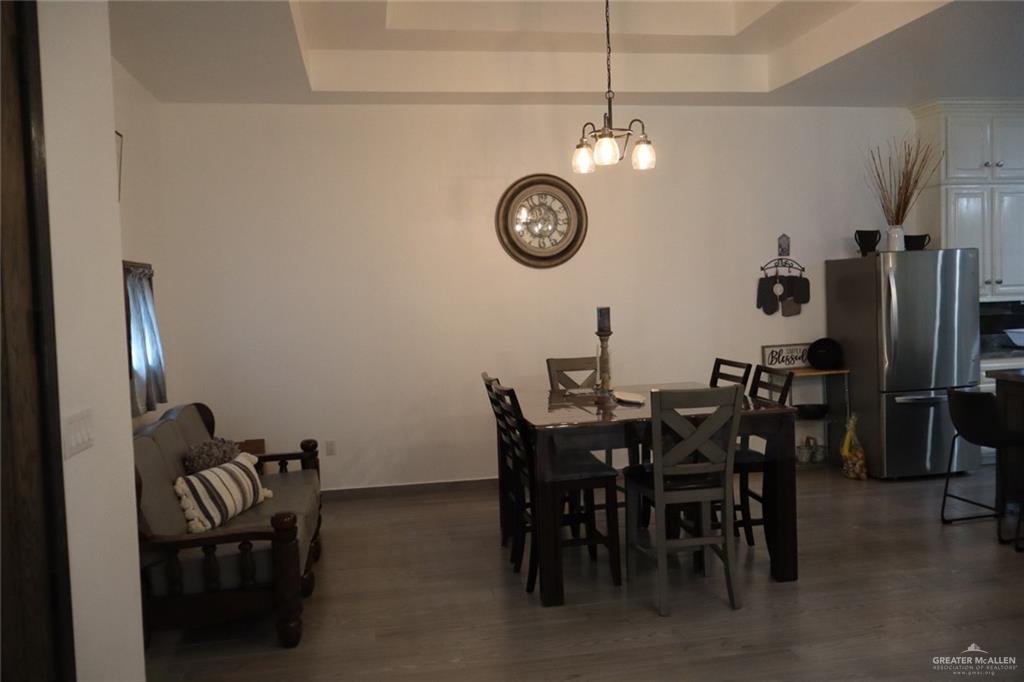 1034 Sunrise Rio Grande City, TX 78582 - Photo 5 of 37 a view of a dining area with furniture and a clock