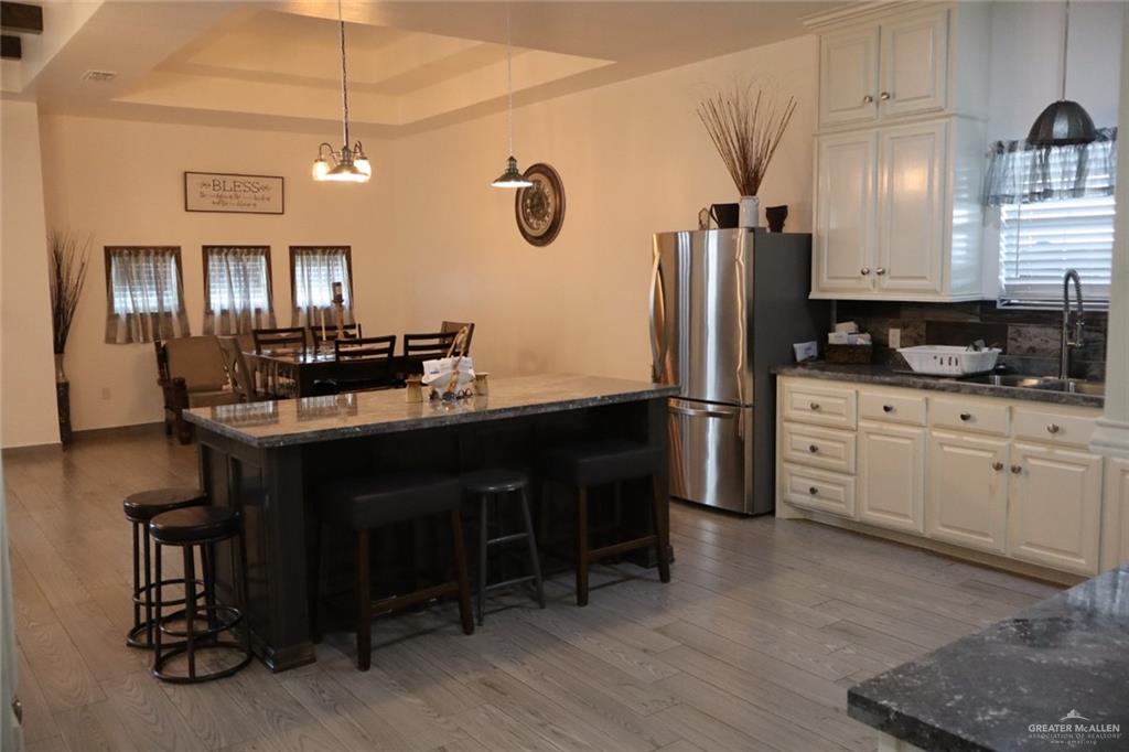 1034 Sunrise Rio Grande City, TX 78582 - Photo 6 of 37 a kitchen with kitchen island granite countertop a sink cabinets and stainless steel appliances