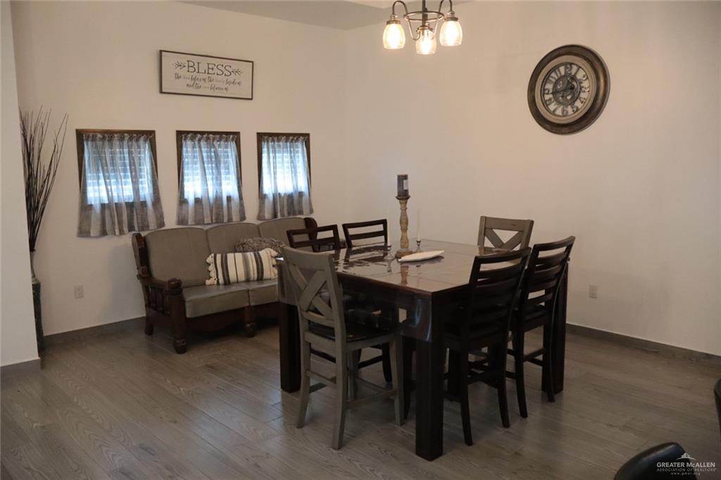 1034 Sunrise Rio Grande City, TX 78582 - Photo 7 of 37 a view of a dining room with furniture and a chandelier