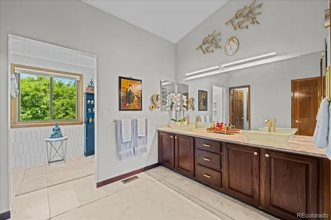 a spacious bathroom with a double vanity sink a large mirror and a bathtub