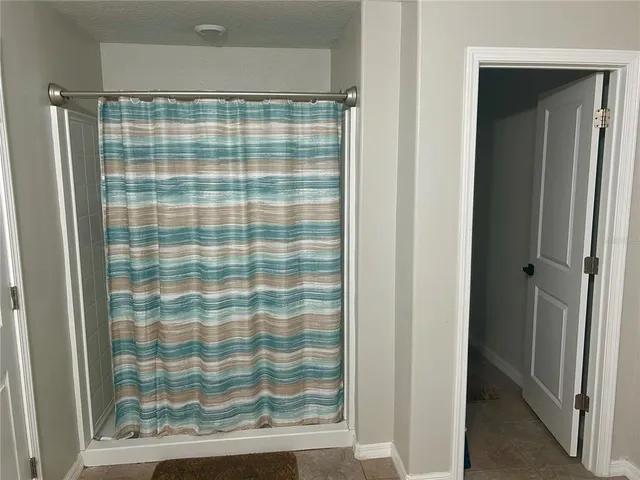 a view of a hallway with closet and a livingroom view