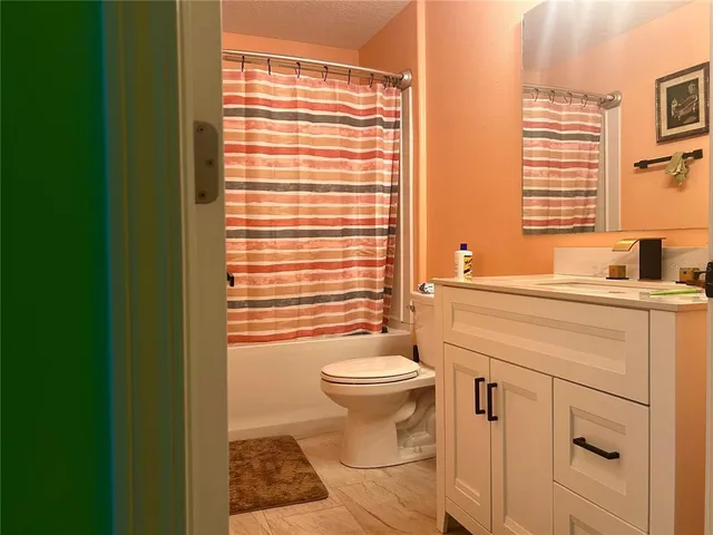 a bathroom with a sink a toilet and tub