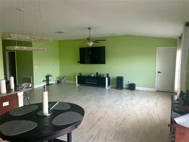 a kitchen with sink table and chairs