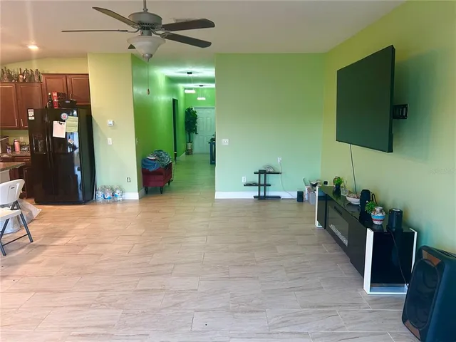 a view of a kitchen with furniture and a flat screen tv