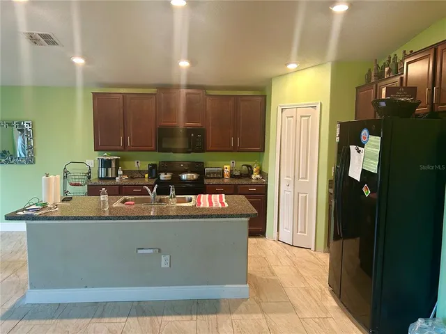 a large bed sitting in a bedroom next to a window