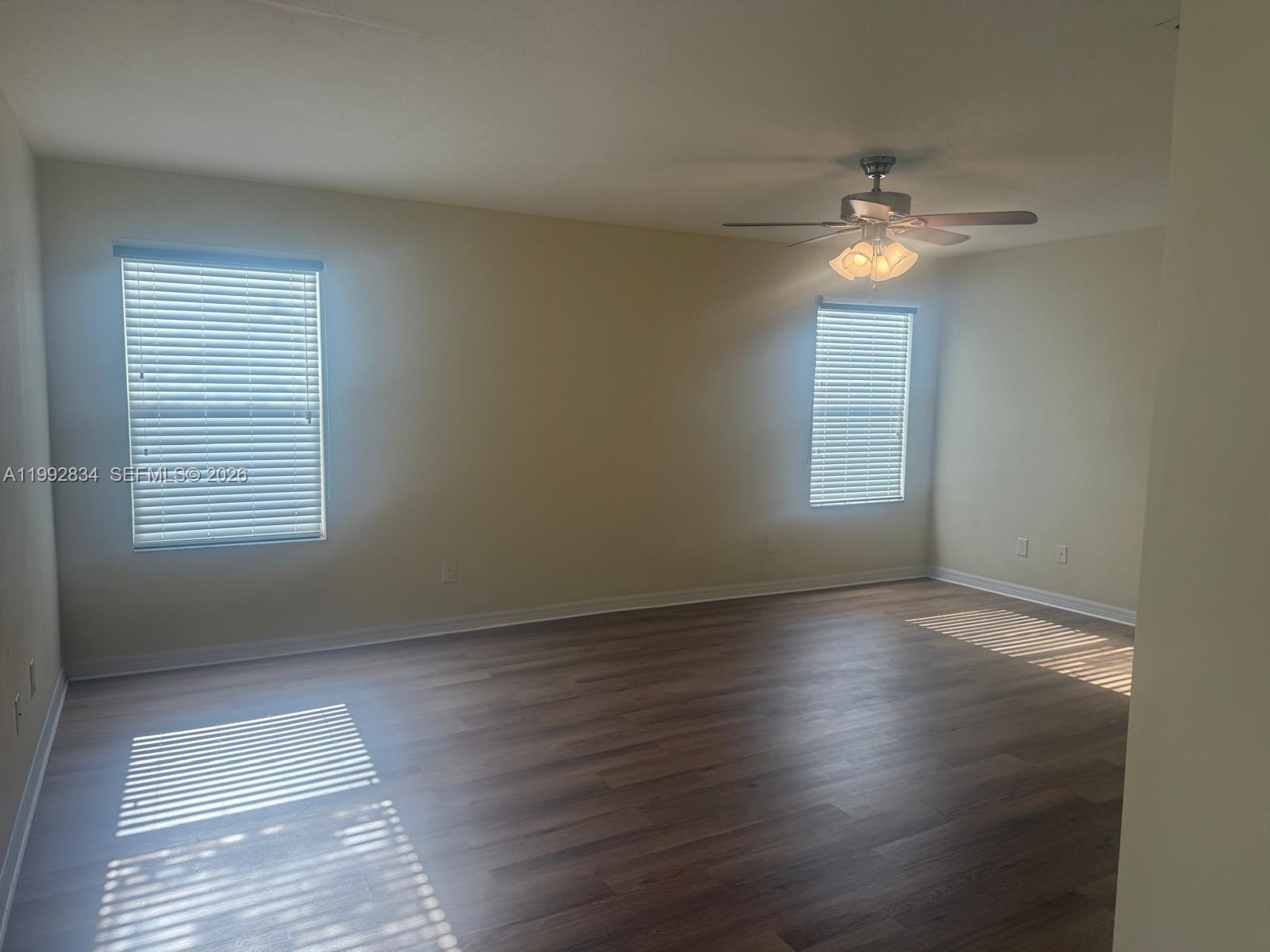 3154 Rodrick Circle Orlando, FL 32824 - Photo 13 of 21 a view of empty room with wooden floor and fan