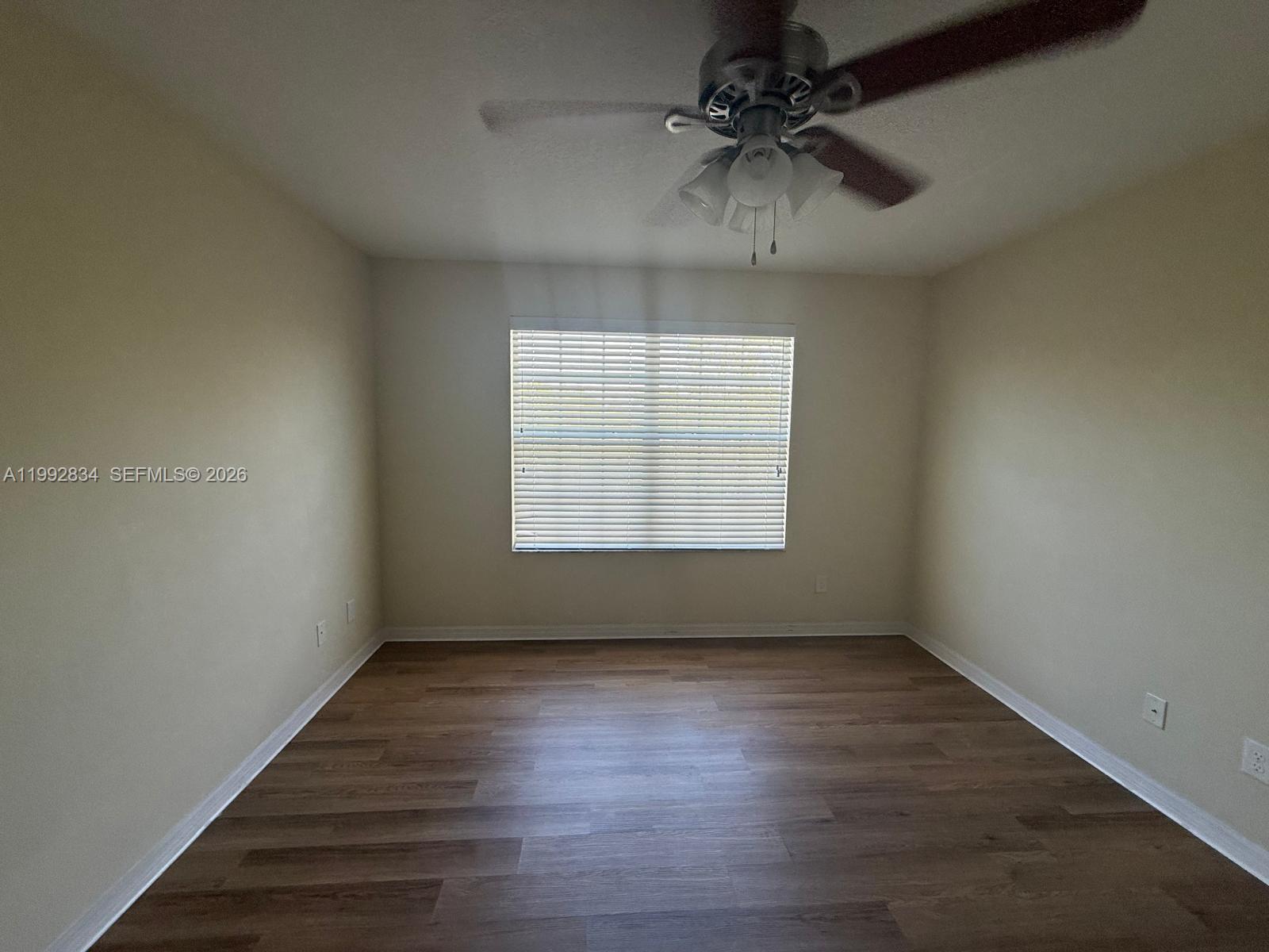3154 Rodrick Circle Orlando, FL 32824 - Photo 16 of 21 wooden floor in an empty room with a window