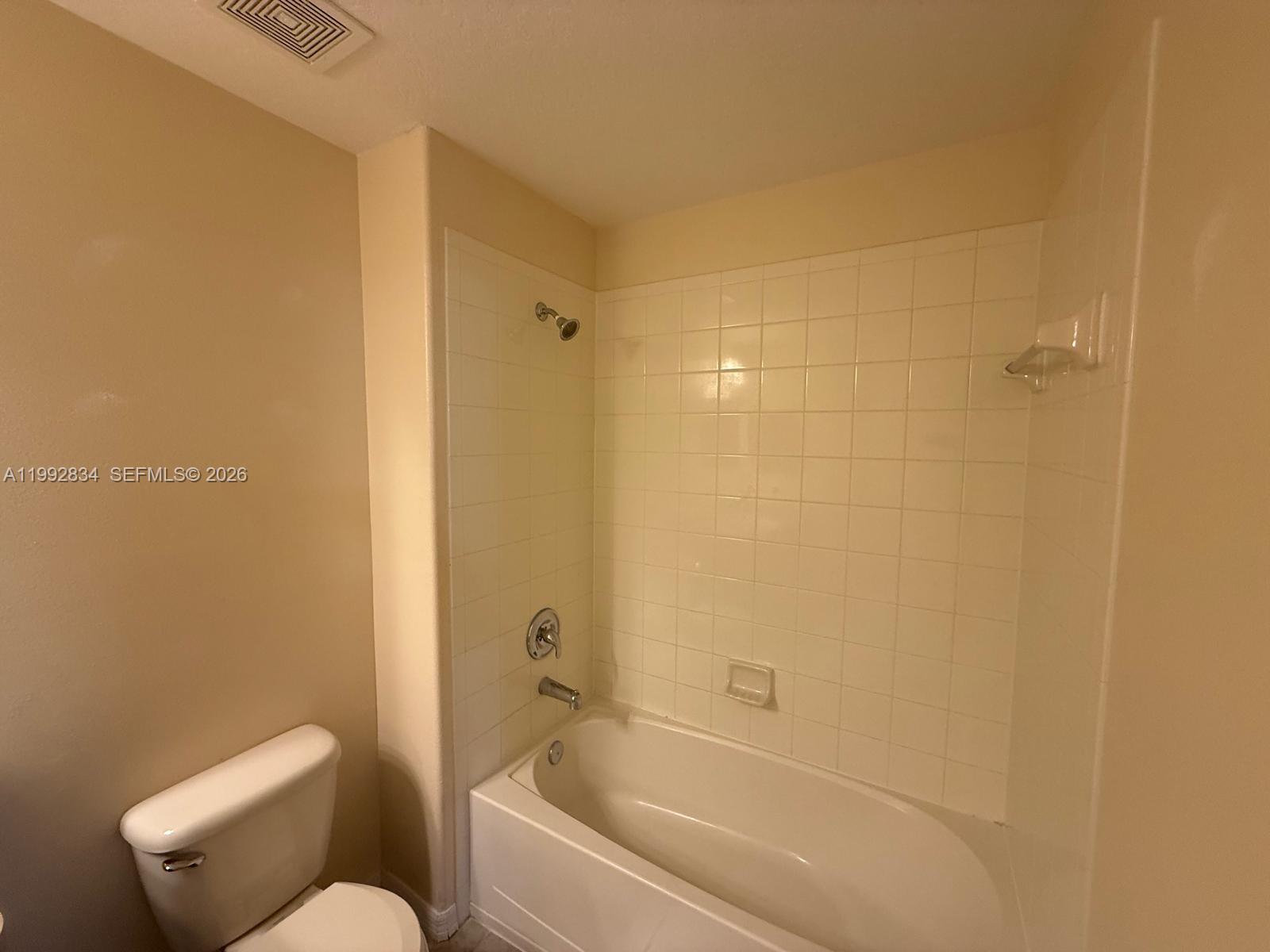 3154 Rodrick Circle Orlando, FL 32824 - Photo 19 of 21 a bathroom with a toilet and bathtub