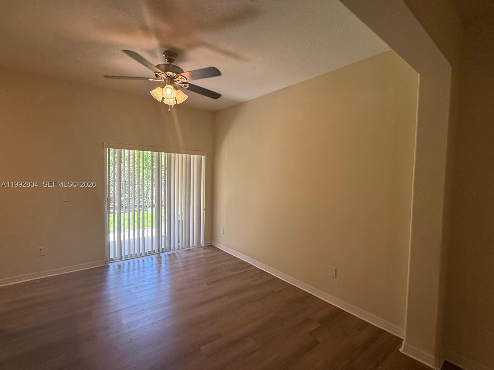 3154 Rodrick Circle Orlando, FL 32824 - Photo 4 of 21 a view of an empty room with wooden floor