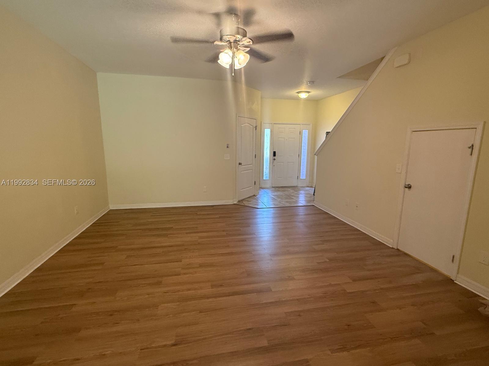 3154 Rodrick Circle Orlando, FL 32824 - Photo 5 of 21 wooden floor in an empty room with a window